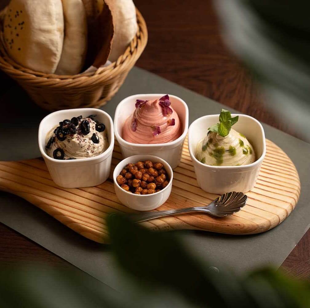 selection  of hummus served with arabic bread