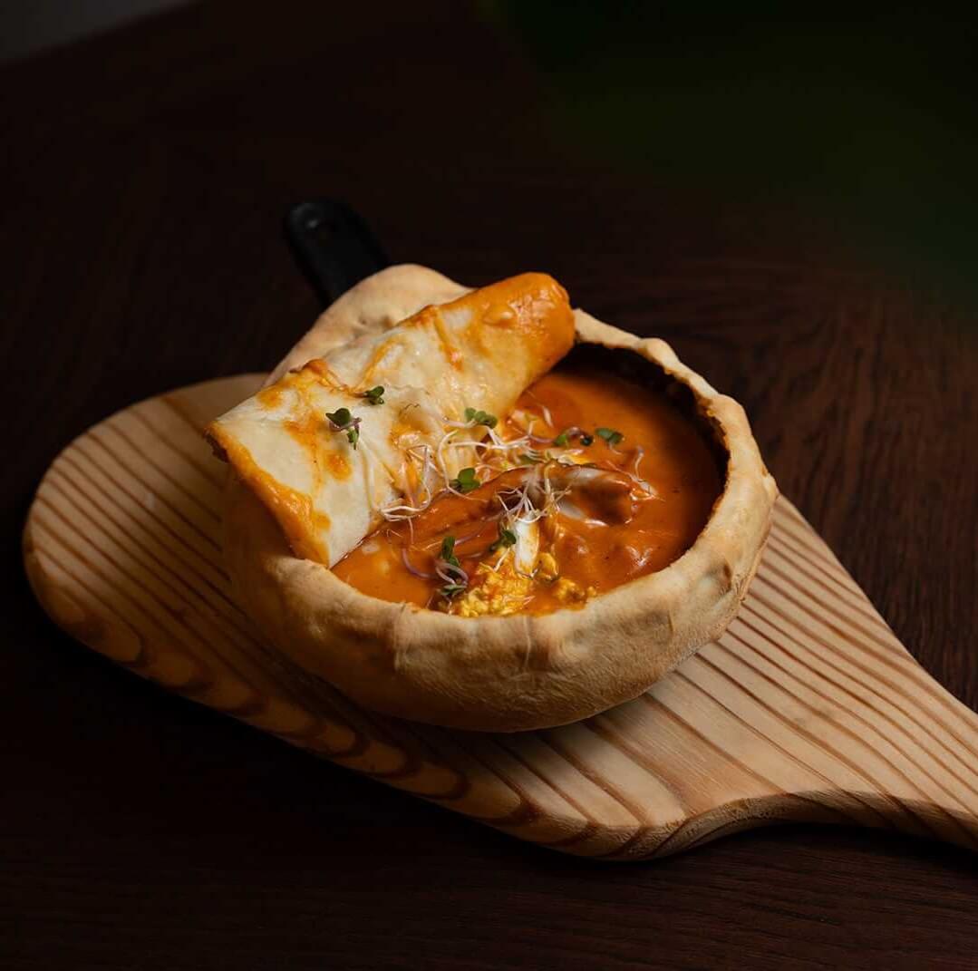 Beaked halloumi with boild egg with tomato cream cheese sauce