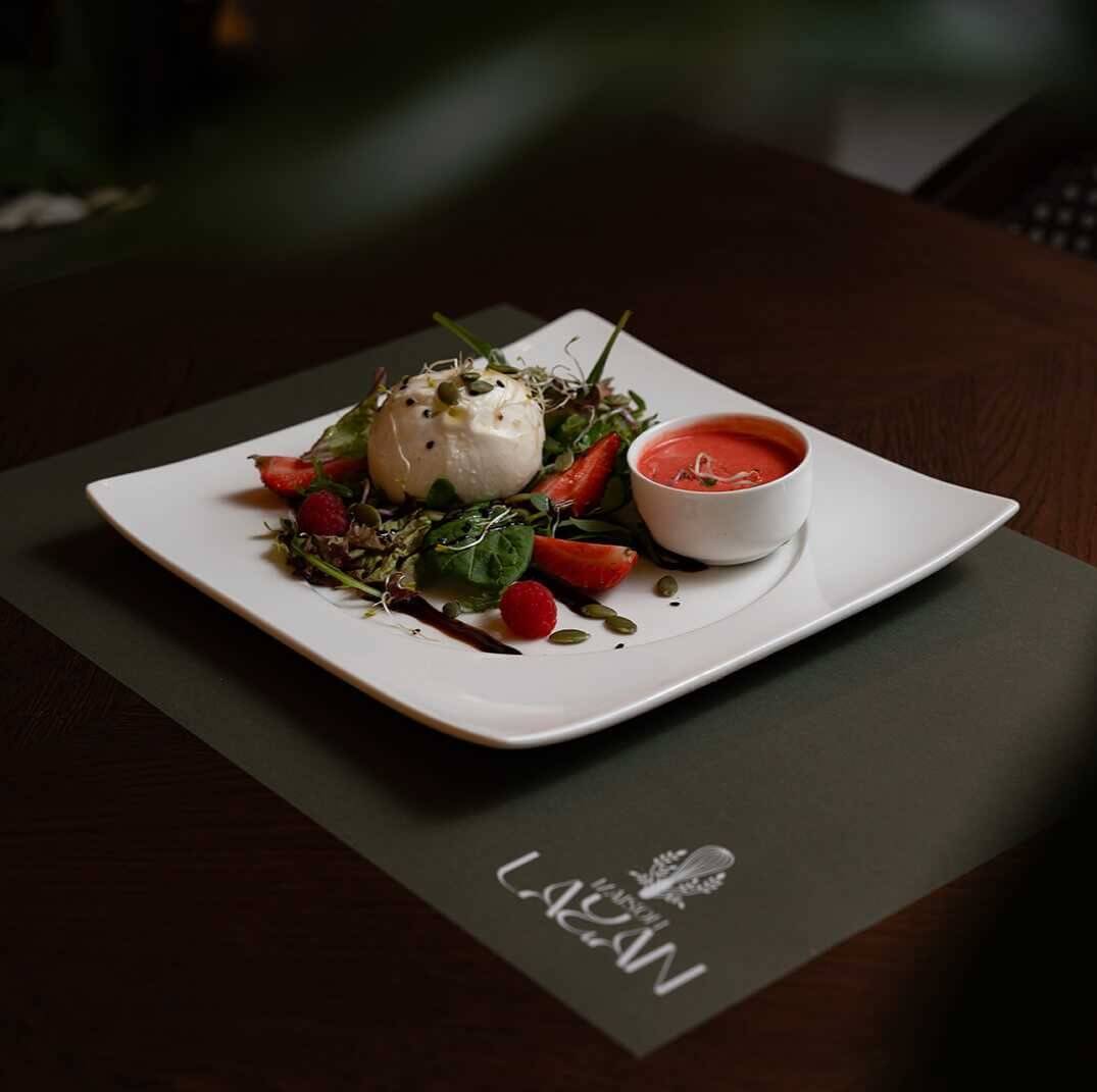 Fresh Burrata with mix leaves and special  raspberry sauce