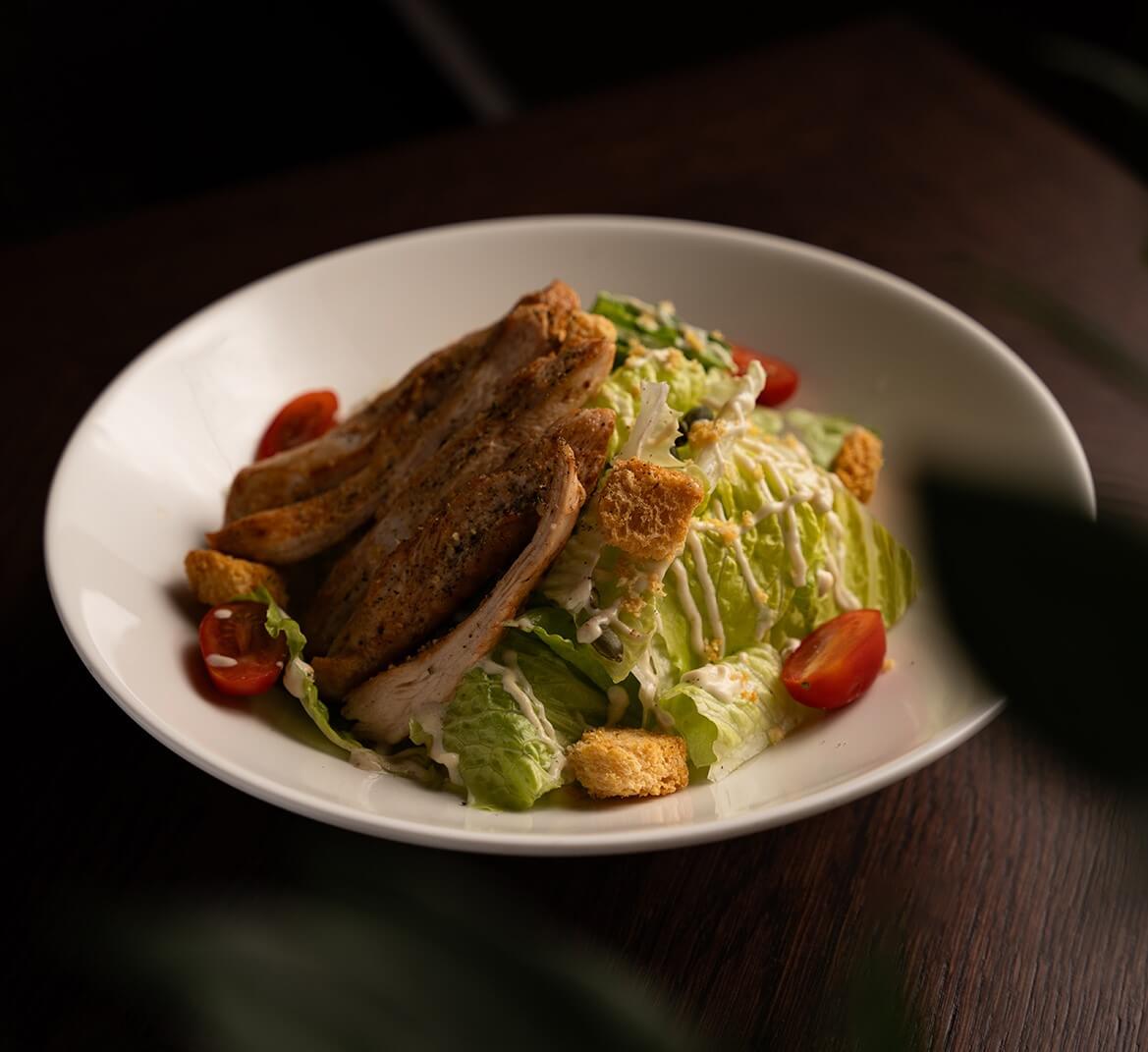 Classic caesar with grilled chicken beaked baguette garlic herbs